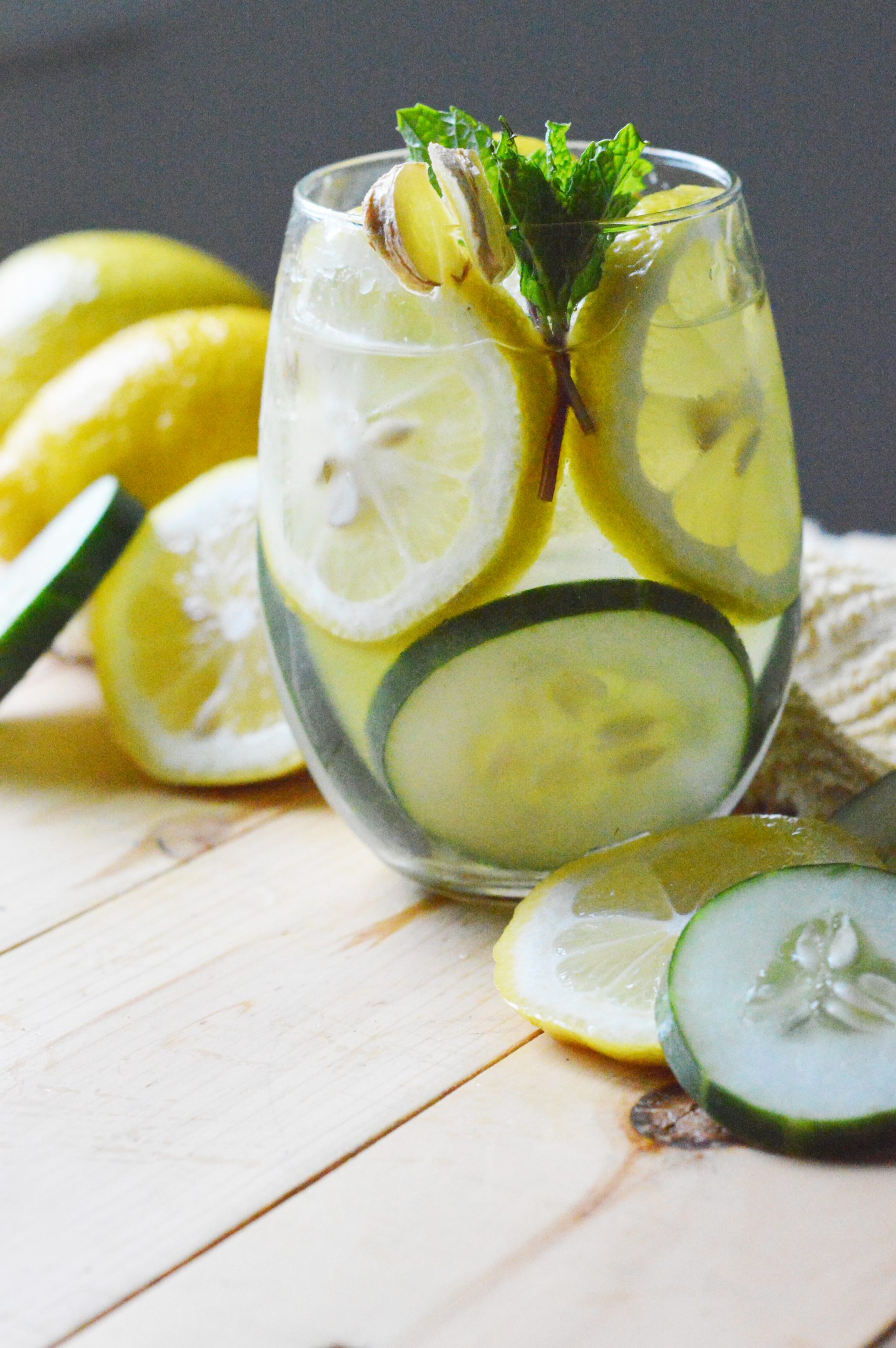 cucumber lemon detox water in glass on wood table
