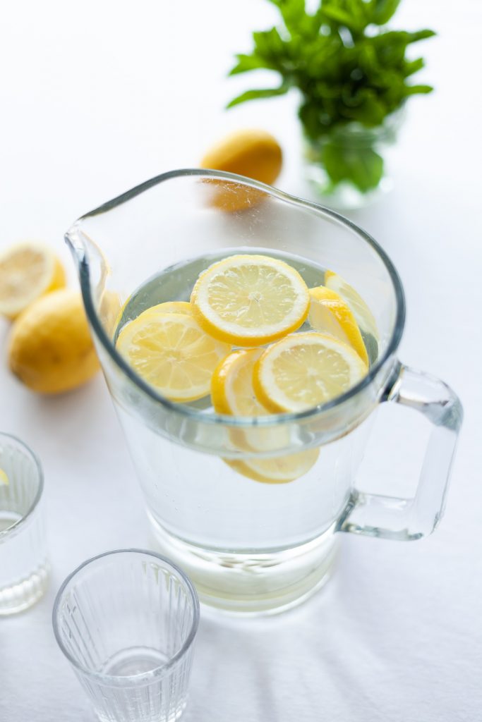 slices of lemon in clear pitcher of water
