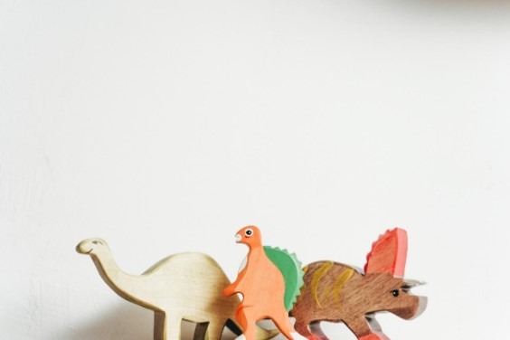 three toy dinosaurs on white background