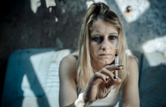 female Drug Addict taking drug injection