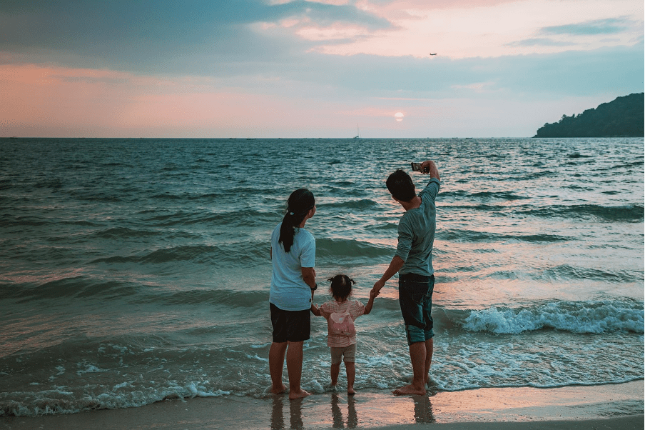 Man taking a perfect family photo at the beach.