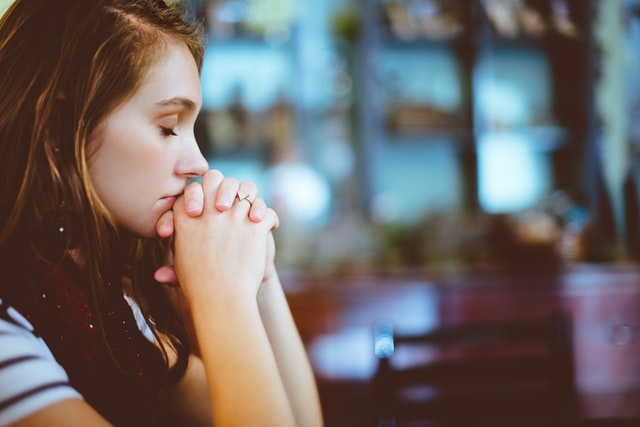 Woman praying in the church.