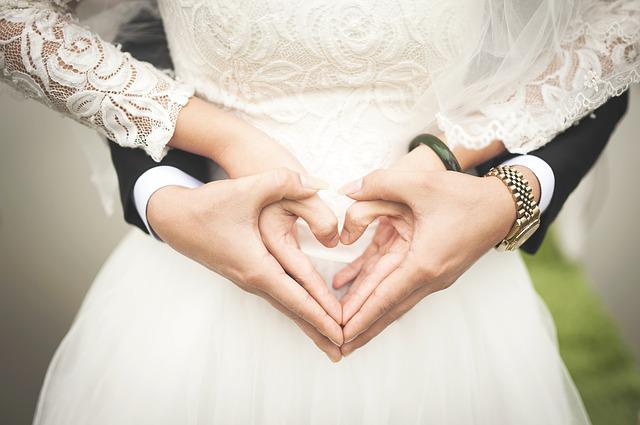 A couple holding hands and getting married.