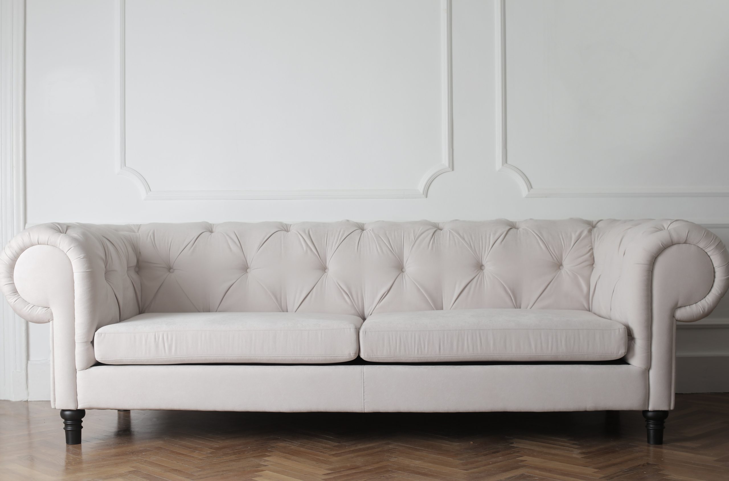 A grey color sofa placed in the living room.