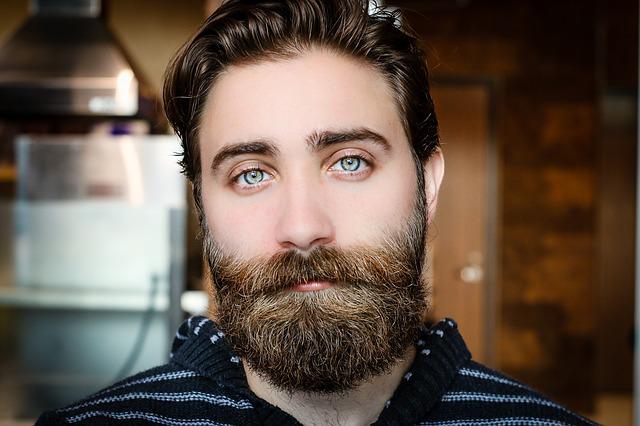 A man flaunting his long beard.