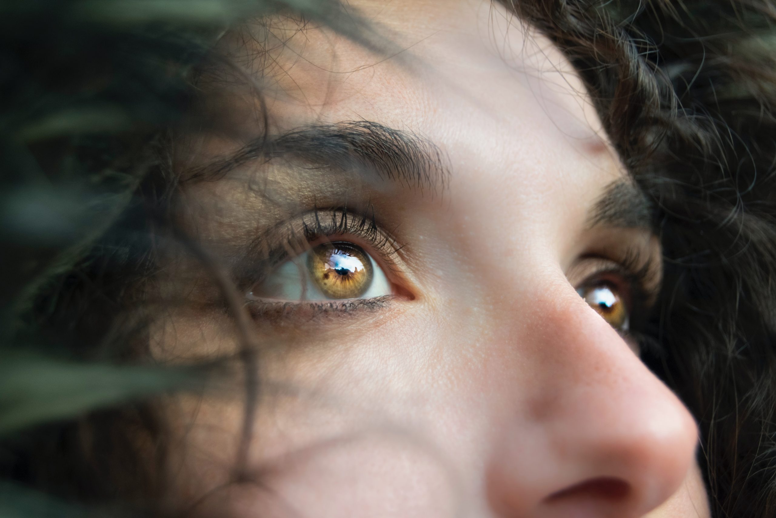 A woman with brown eyes staring at something.