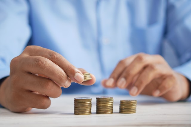 Man counting coins and stacking them.