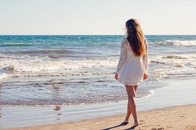 A woman standing near the beach.