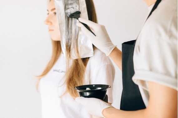 A woman getting hair treatment.