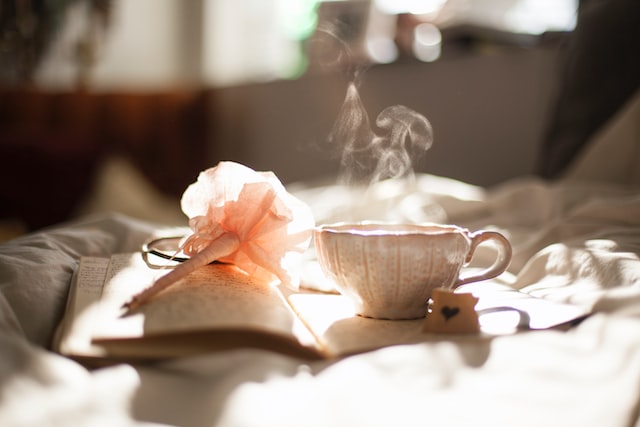 Smoke coming out from a cup placed on a book.