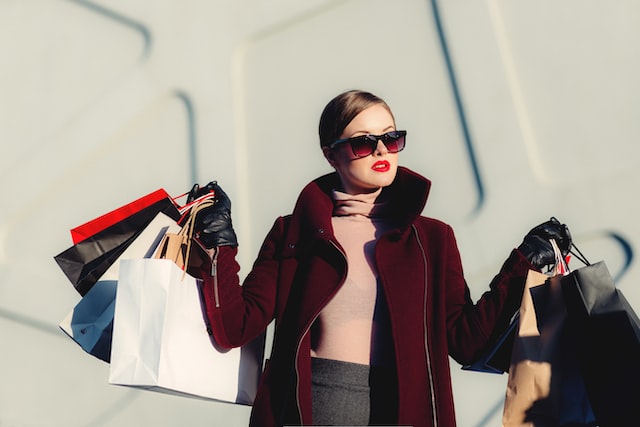 A woman with shopping bags in her hand.