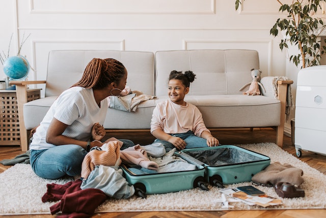 Mother and child packing their luggage.