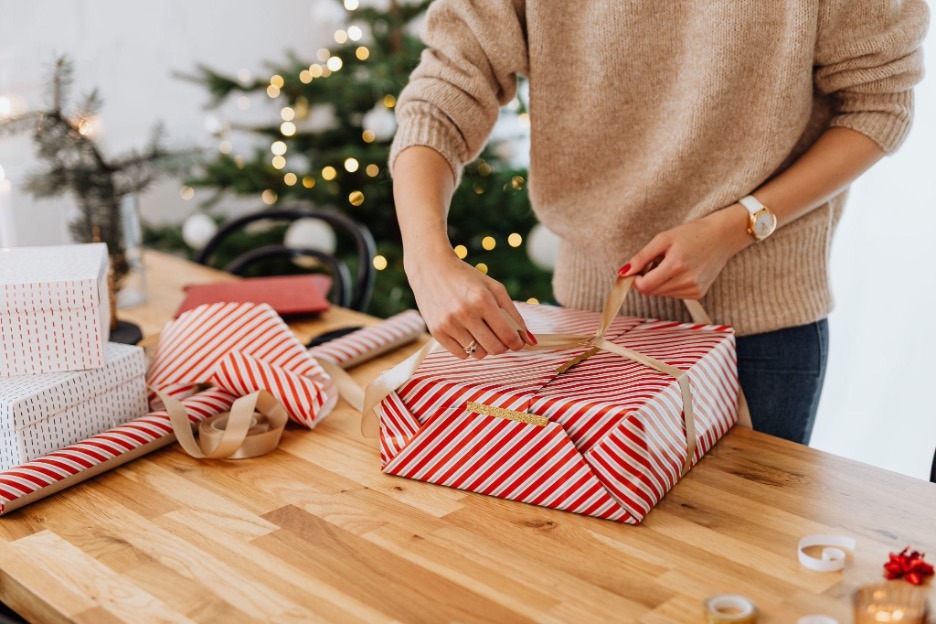 A man packing a gift.