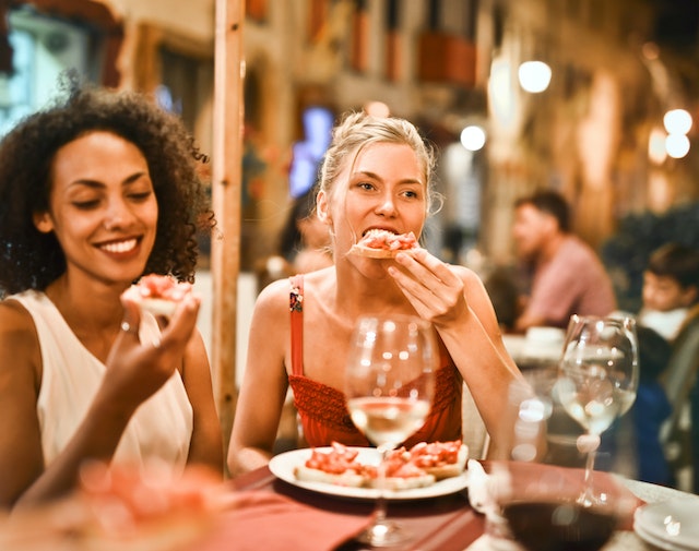 Women enjoying Italian food.