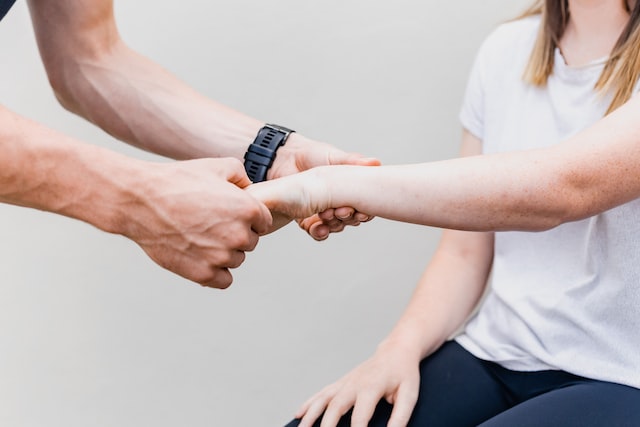 A man holding a woman's hand.