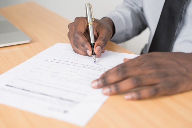A man signing documents.