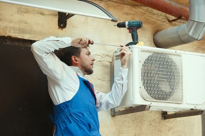 Man repairing the air conditioner.