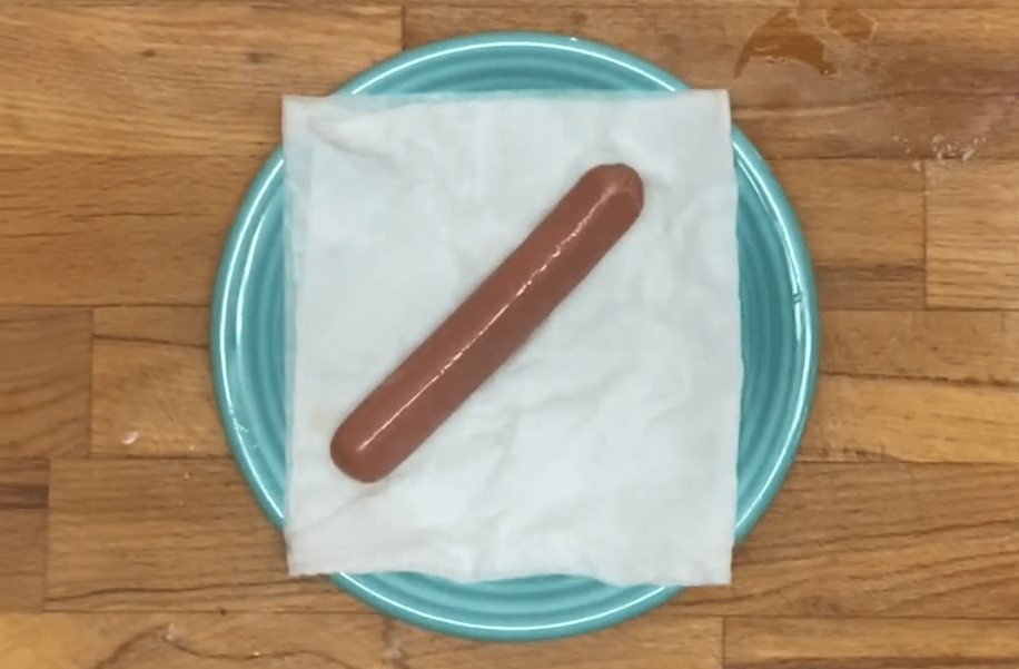 Use a paper towel to cover your hot dogs